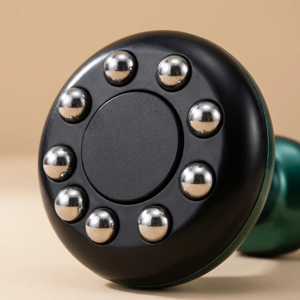Close detail of the bell head, chrome massage balls and stone plate